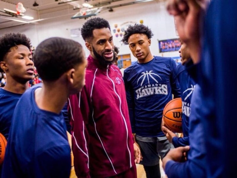 Flint native Roy “Rackk” Jackson Jr. gives a pep talk to the team during a Hamady High School basketball game.