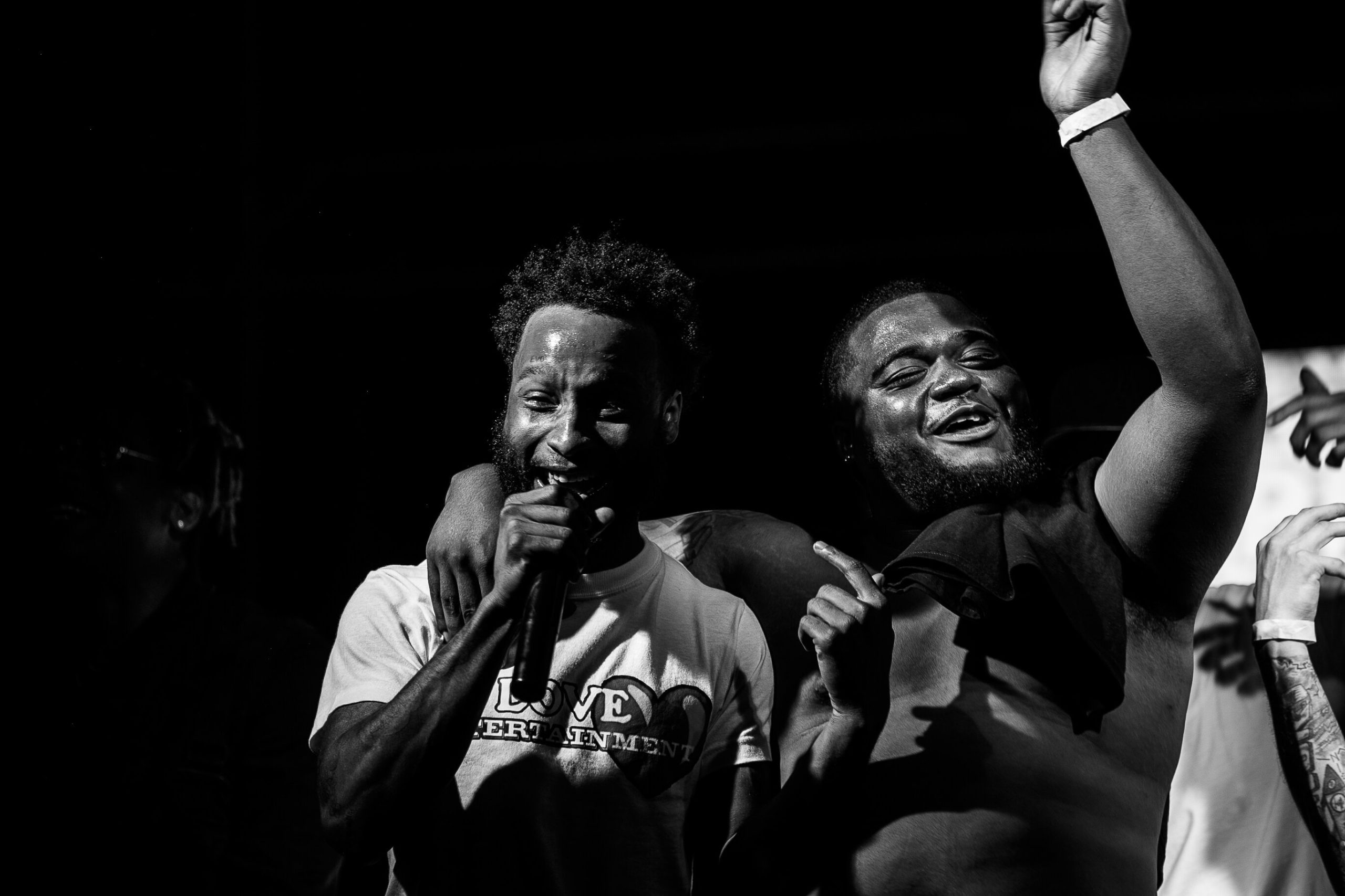 Glizzy Fest attendants jump on stage and perform during Glizzy Fest on Saturday, August 6, 2022 in Buckham Alley, downtown Flint. (Jenifer Veloso | Flintside.com)