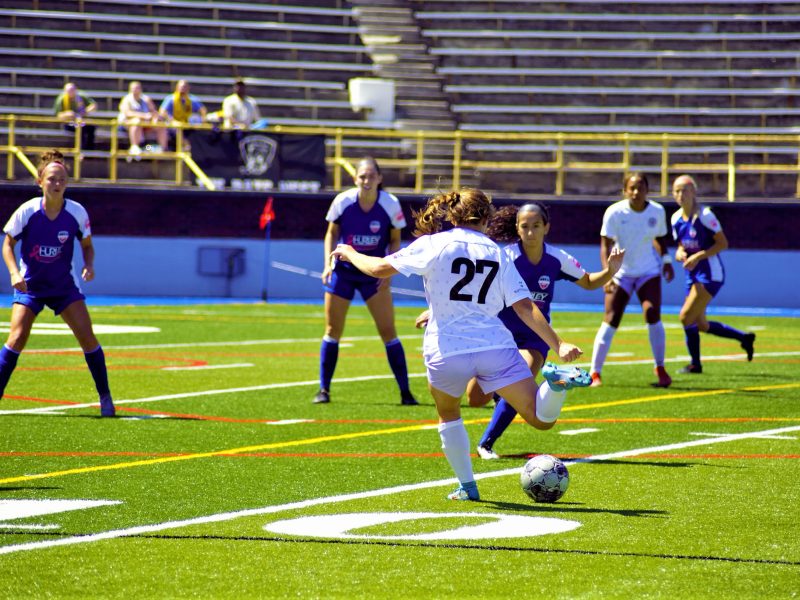 The Flint City AFC playing a tough game against the Racing Louisville FC team.
