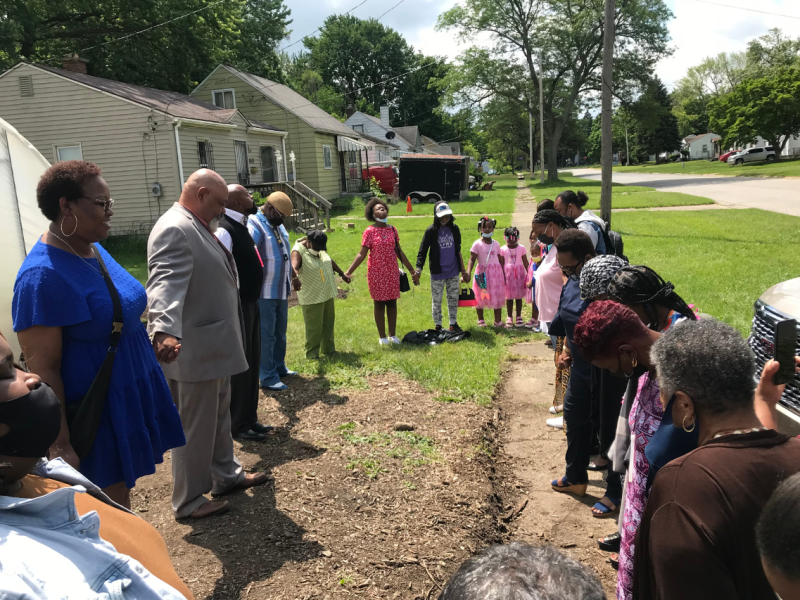 Residents outside of EJ's Garden giving thanks and prayer.
