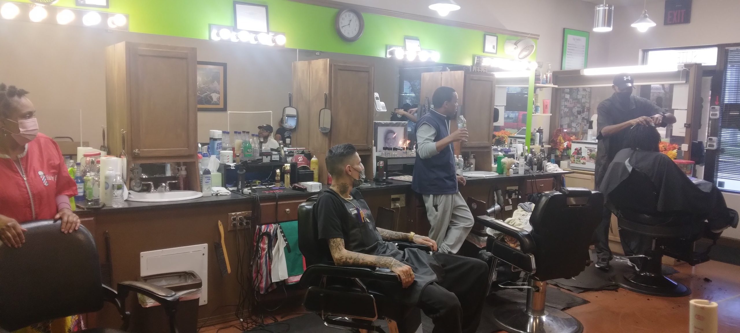 Patrons enjoy lively conversation and barbershop antics inside Big Daddy's Barber Shop.