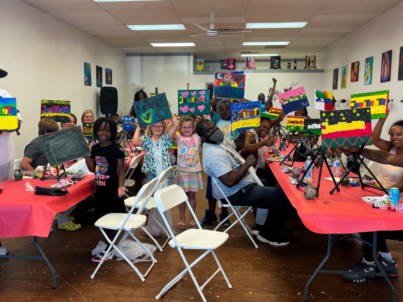 A packed house of Flint residents showing off their newly created Juneteenth artwork.