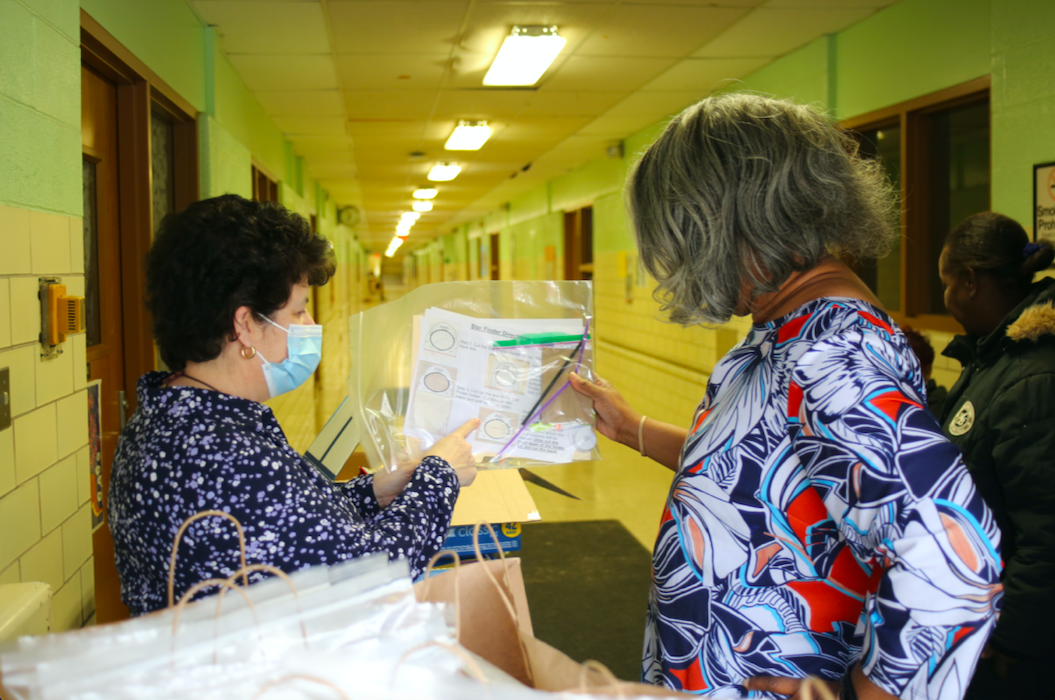 Educators and volunteers show up to pass out STEM learning packets which feature several science-based assignments.