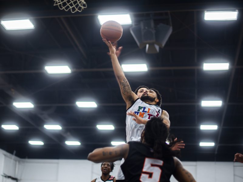 Malik Ellison wards off two Toledo Glass City BC defenders as he goes for a basket in the second quarter.