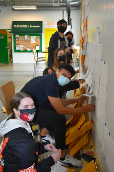 A group of students installs the Hostile Terrain 94 display.