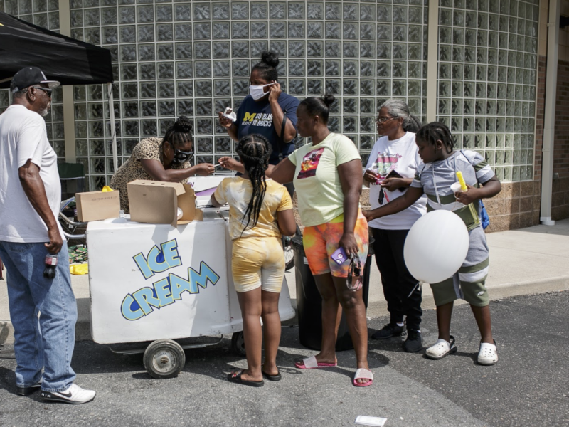 Tasha Brown, 29, with friends and family, purchases ice cream at the Hamilton Healthcare Network Family Fun Day.