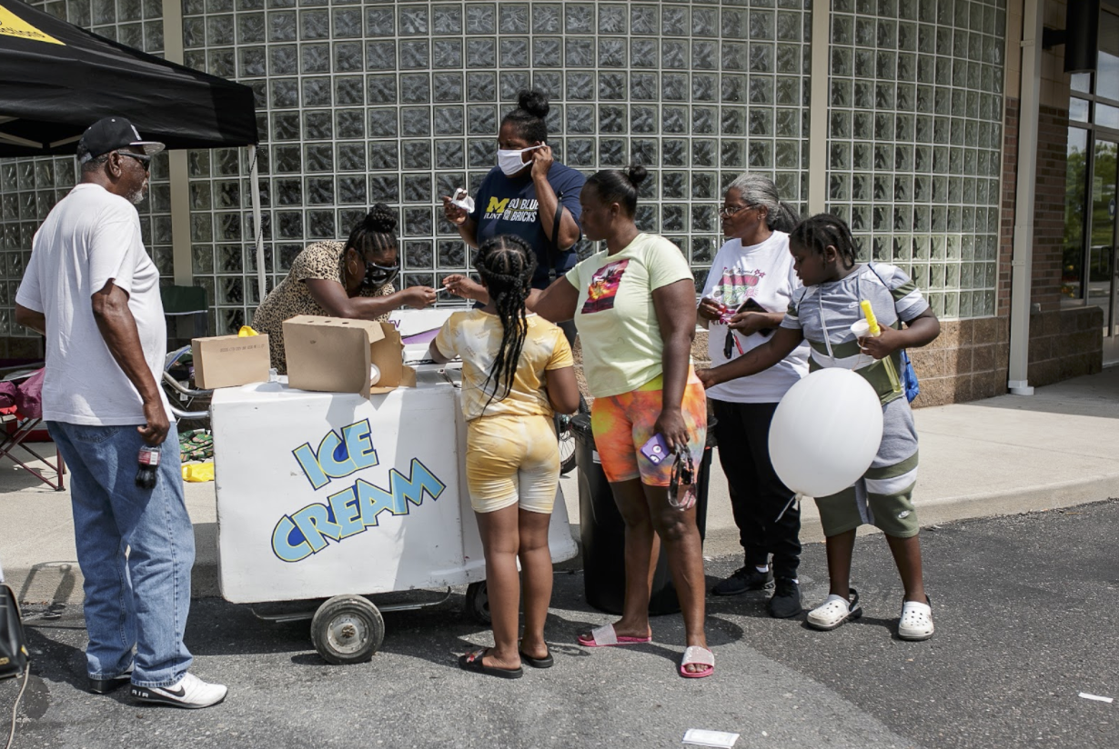 Tasha Brown, 29, with friends and family, purchases ice cream at the Hamilton Healthcare Network Family Fun Day.