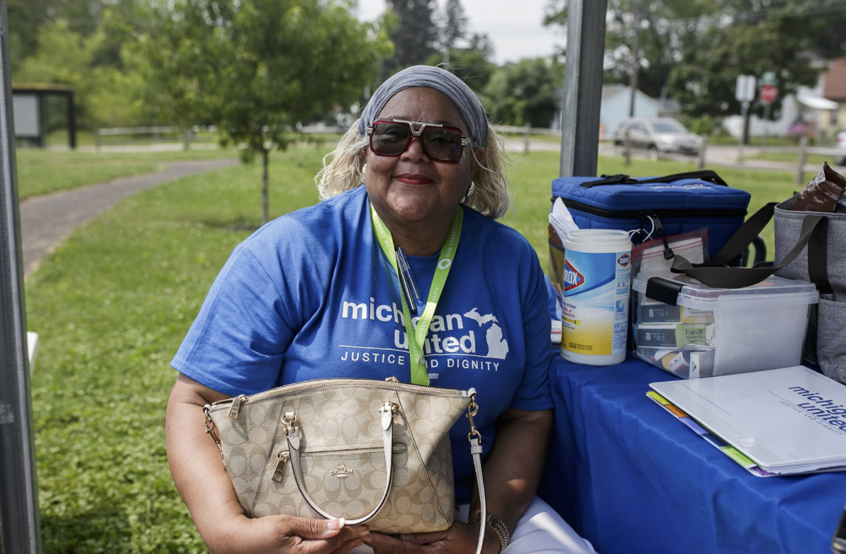 Joyce Ellis McNeal, a Michigan United public health navigator coordinator, sits in the pavilion at the Eastside Franklin Park Neighborhood pocket park during the annual craft fair.