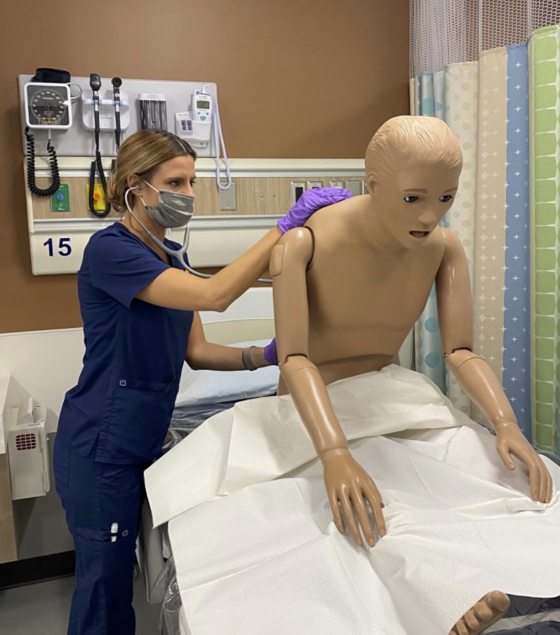 A UM-Flint nursing student completing her Final Integrated Exam using the "low-fidelity mannequin."