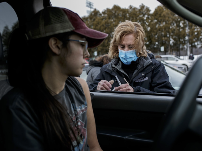Miryea Fajardo of Flint receives her Moderna Vaccine at Northwestern High School's vaccine clinic.