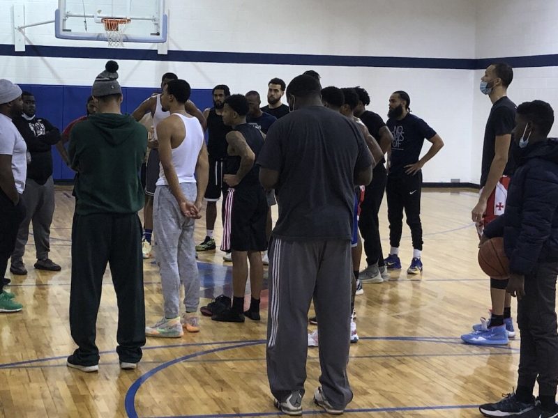 Kevin Mays (left, grey hat) talks with players trying out for Flint United during a training camp in January 2021.