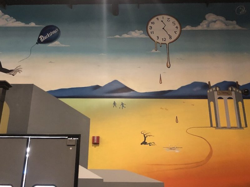 A mural by Zach Curtis just above the kitchen entrance at Blackstone's Smokehouse.