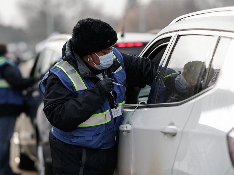 A health department nurse administers a vaccine to a patient during the drive through vaccine clinic at Northwestern.