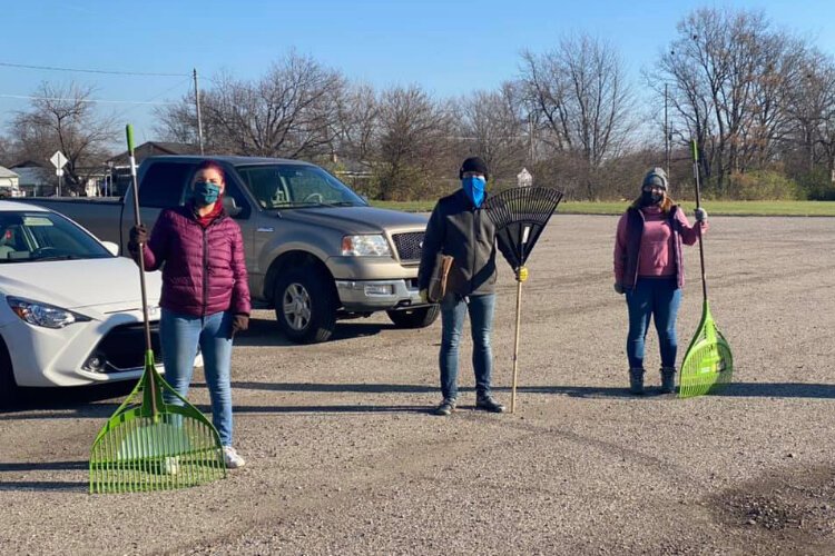 Volunteers line up with their rakes ready to take on the day.