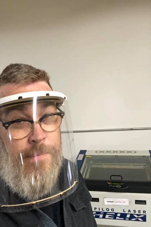 Michael Wright, co-founder of Factory Two, tries on his laser cut face shield design on March 26. 