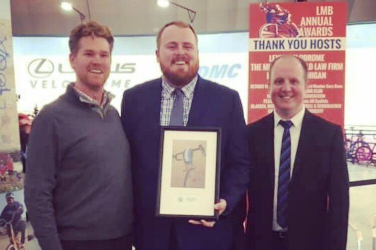 Danny Moilanen (center) accepts the Club of the Year award from the League of Michigan Bicyclists on Oct. 19, 2019.