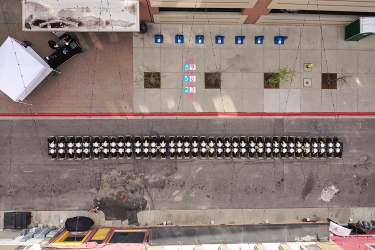 The table is set, awaiting the guests for Flint's first Dinner Under the Lights in Buckham Alley