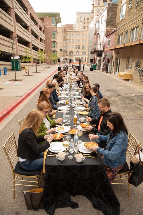 All guests at Dinner Under the Lights were seated at one, extremely long table during the event, a fundraiser for Friends of the Alley.