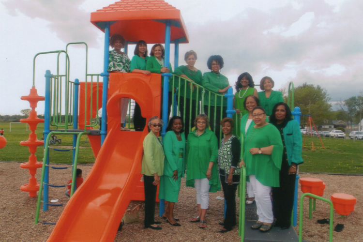 Members of The Links Incorporated Flint Area Chapter pose at a playground they helped build with dollars from their Flint Kids Matter fund.