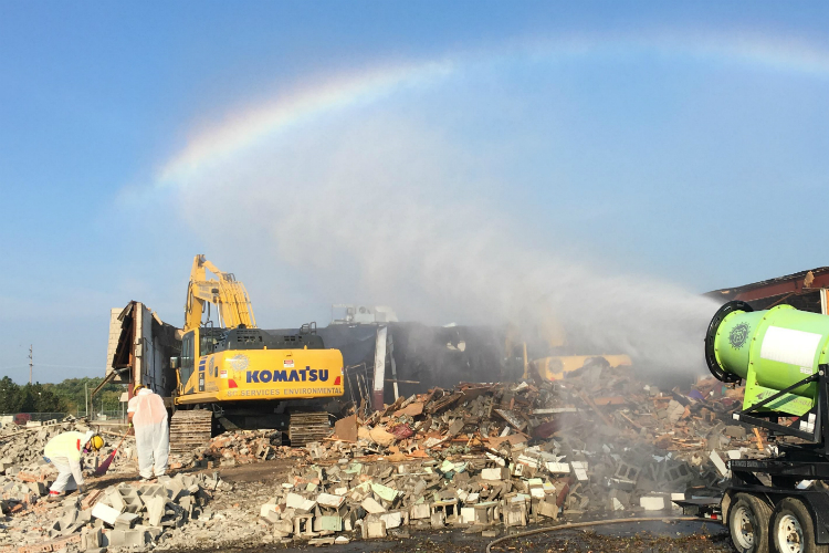 Water sprayed on a demolition site creates a rainbow at at Clio and Pierson roads in 2018.