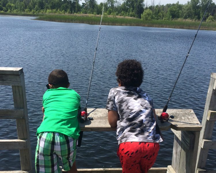The boys wait, as patiently as possible, for a bite during the Kids Fishing Club event at Buell Lake this month.