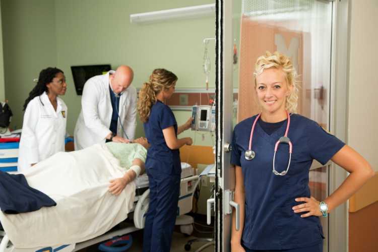 Nursing students at the University of Michigan-Flint pose in the state-of-the-art simulation lab. The nursing program will expand almost 50 percent in January.