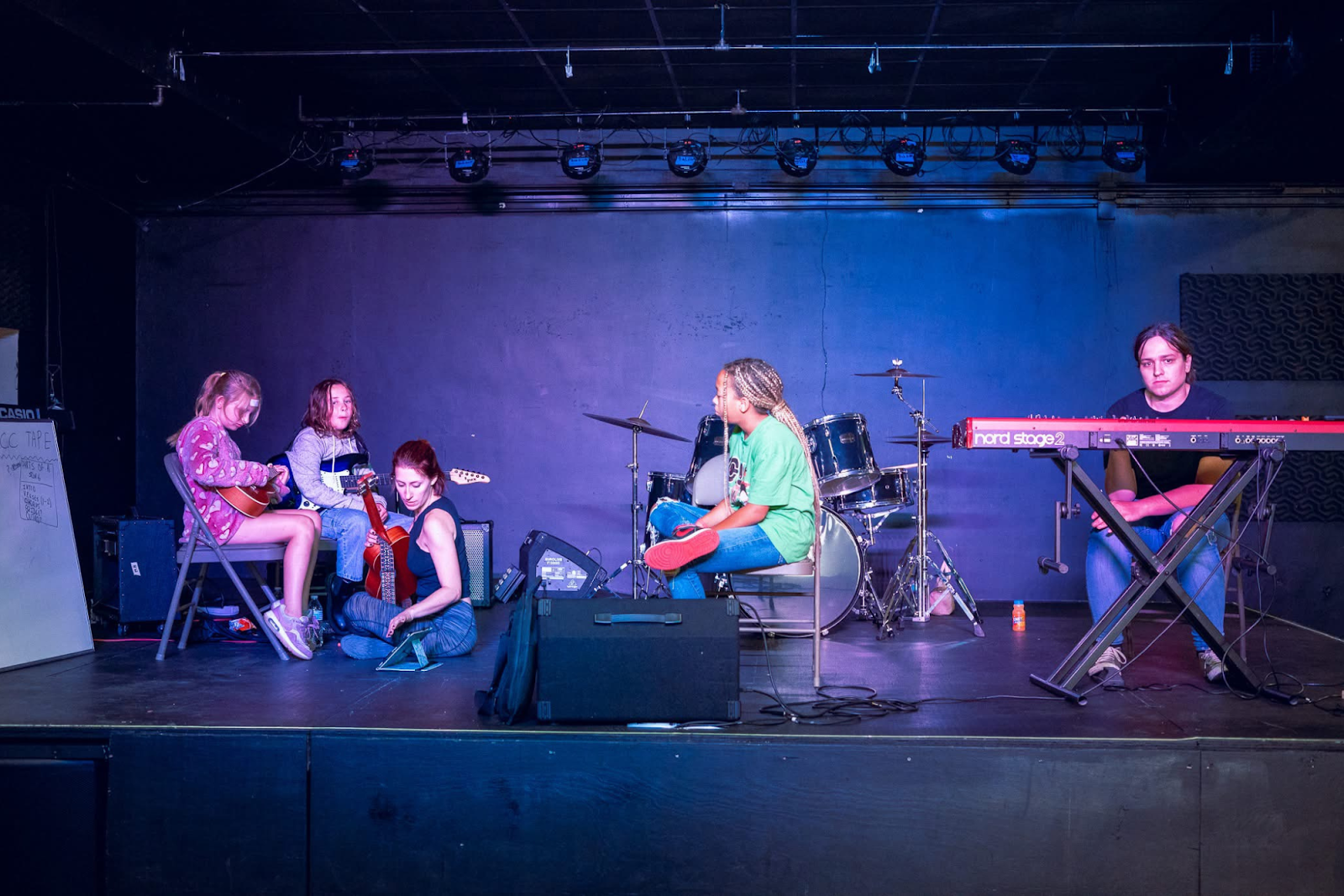 Youth learn how to play instruments as they gear up for their stage debuts.